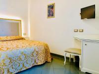 a bedroom with a bed and a desk and a television at Hotel Marte in Venice