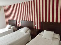 A bed or beds in a room at Hotel Rural Nova Ruta