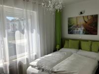 A bed or beds in a room at Enjoyit Rooms