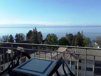 a balcony with a view of the water at Hôtel Evian Express - Terminus in Évian-les-Bains