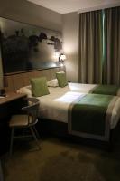 a hotel room with a bed and a desk and a chair at Le Mouton Blanc in Le Mont Saint Michel