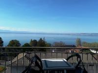 a balcony with a view of the water at Hôtel Evian Express - Terminus in Évian-les-Bains