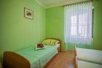 Postel nebo postele na pokoji v ubytování Apartments Dabović