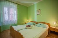 Postel nebo postele na pokoji v ubytování Apartments Dabović