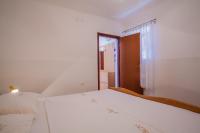 Postel nebo postele na pokoji v ubytování Apartments Dabović