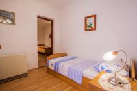 Postel nebo postele na pokoji v ubytování Apartments Dabović