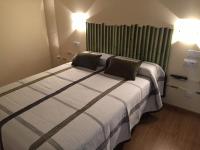 Postel nebo postele na pokoji v ubytování Hostal Santa Baia