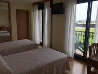 Postel nebo postele na pokoji v ubytování Hostal Santa Baia