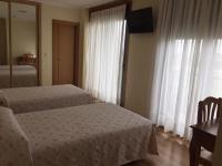 Postel nebo postele na pokoji v ubytování Hostal Santa Baia