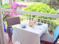 a white table with a basket of food on a balcony at Appartement Nice Port in Nice