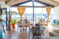 Un restaurante con mesas y sillas y vista al agua. en Blue Lagoon Hotel and Marina Ltd, en Kingstown