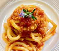 a plate of pasta with meat sauce and noodles at Locanda Vesuna Hotel Countryhouse in Pienza
