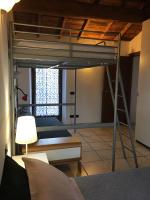 a bedroom with a bunk bed with a ladder at Villa Broglia House in Verona