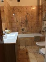 a bathroom with a tub and a toilet and a sink at Villa Broglia House in Verona