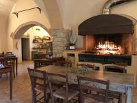 a kitchen with a table and a large fireplace at Agriturismo San Ottaviano in Monterotondo
