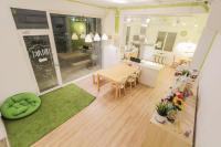 a living room with a table and a dining room at T-Life Hostel in Longjing