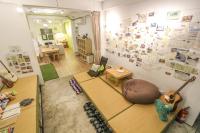 a room with a guitar on the wall and a room with a guitar at T-Life Hostel in Longjing