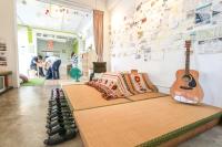a room with a bed and a guitar on the wall at T-Life Hostel in Longjing