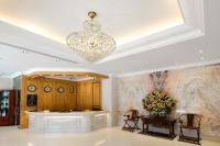 a lobby with a chandelier and a table and chairs at Hotel Sunshine in Kaohsiung