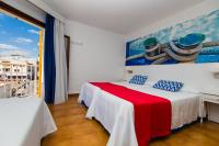 Łóżko lub łóżka w pokoju w obiekcie Hostal Cala Ratjada