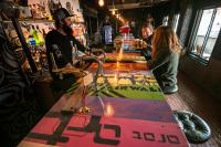 a group of people standing around a bar at Hotel Villa Hakuba by HHG in Hakuba