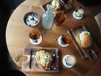 a wooden table topped with plates of food and drinks at Hotel Villa Hakuba by HHG in Hakuba