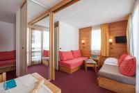 a room with a bed and a couch and a chair at Résidence Pierre &amp; Vacances Emeraude in Belle Plagne