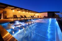 a large swimming pool with lights on top of a building at Olivia Balmes Hotel in Barcelona