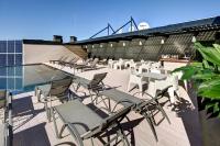 a group of tables and chairs on the roof of a stadium at Olivia Balmes Hotel in Barcelona