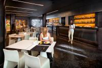 a man and a woman standing in a restaurant at Olivia Balmes Hotel in Barcelona