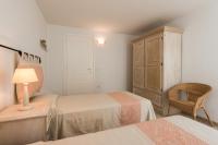 A bed or beds in a room at Apartment in S'Abba e Sa Pedra with pool