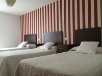 A bed or beds in a room at Hotel Rural Nova Ruta