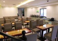 a restaurant with tables and chairs and a bar at Shanghai Dihang Boutique Hotel Pudong Airport Branch - Provides shuttle service to Pudong Airport and Disneyland in Shanghai