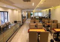 a dining room with tables and chairs in a restaurant at Shanghai Dihang Boutique Hotel Pudong Airport Branch - Provides shuttle service to Pudong Airport and Disneyland in Shanghai