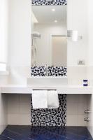 a white bathroom with a sink and a mirror at Hotel Nice in Sorrento