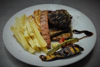 un plato de comida con carne y patatas fritas en Stefanosplace ApartHotel Sea View, en Barbati