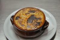 una taza de café en un plato sobre una mesa en Stefanosplace ApartHotel Sea View, en Barbati