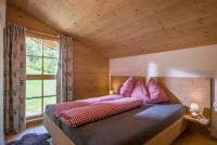 A bed or beds in a room at Chalet Auszeit