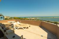a balcony with chairs and a view of the ocean at MSR Port Hotel in Mangalia