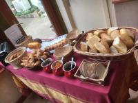 a table with a bunch of bread and baskets at Hôtel aux Bruyères in Orbey