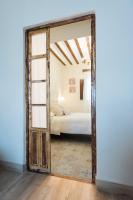 A bed or beds in a room at La Casa de la Vieja - Rustic & Charming Appartments