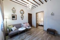 A bed or beds in a room at La Casa de la Vieja - Rustic & Charming Appartments