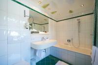 a bathroom with a sink and a shower and a tub at Alpenland - Das Feine Kleine in Lech am Arlberg