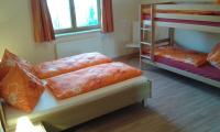 A bed or beds in a room at Landhaus Oberlehen