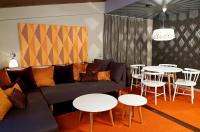 a living room with a couch and tables and chairs at Original Sokos Hotel Vaakuna Rovaniemi in Rovaniemi