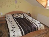 A bed or beds in a room at A+S Penzion Podzamok