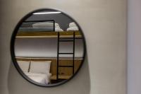 a mirror reflecting a bedroom with two bunk beds at Green Hotel in Magong