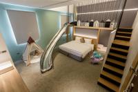 a bedroom with a bed and a slide in it at Green Hotel in Magong