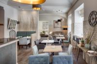 a restaurant with tables and chairs and a bar at Hotel Florenc in Prague