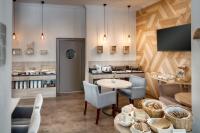 a room with a table and chairs and a kitchen at Hotel Florenc in Prague